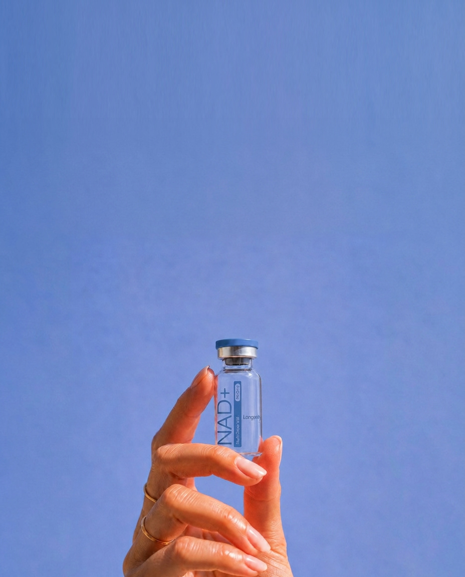Hand holding a clear pep'd treatment vial